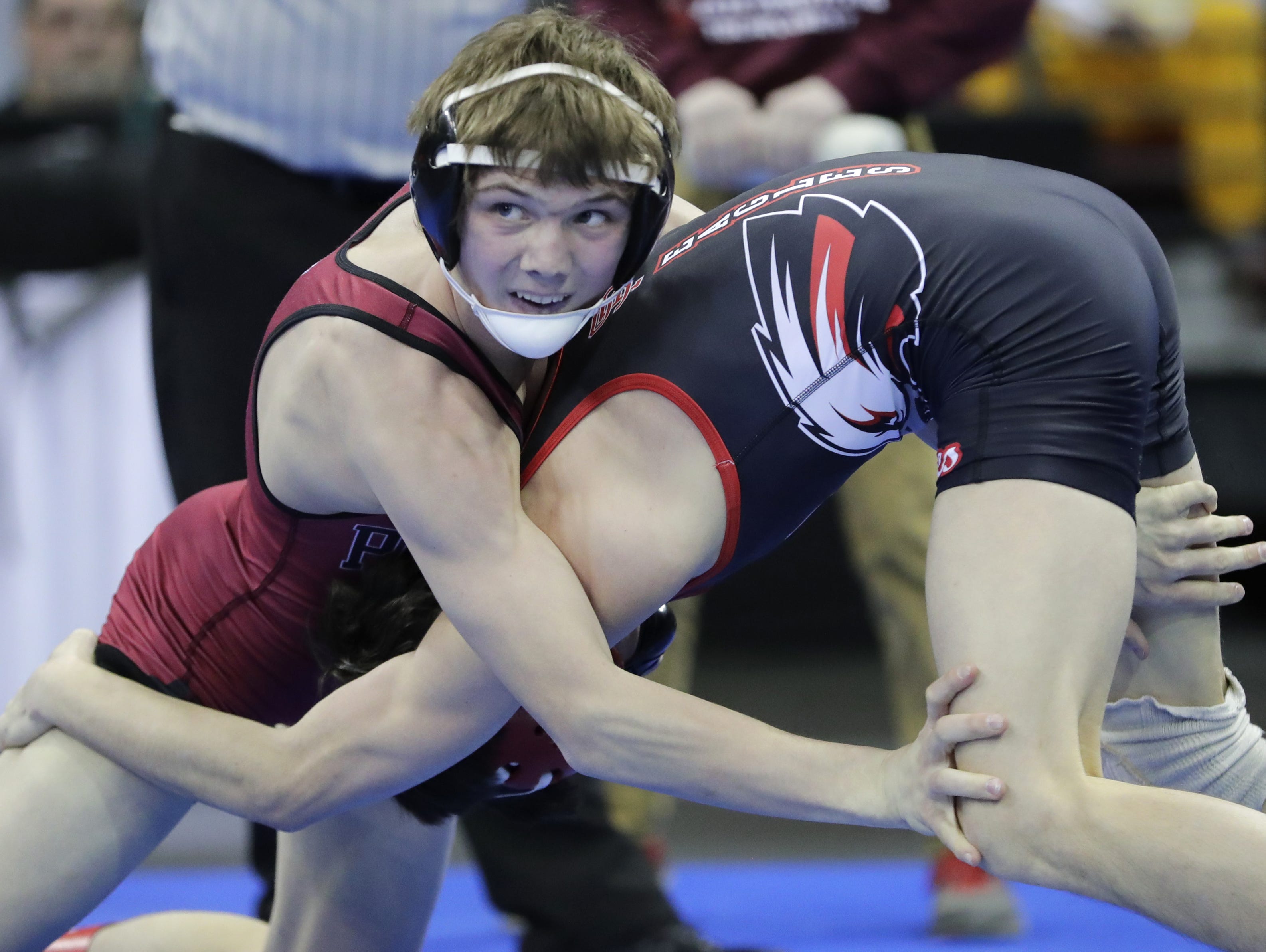 Pulaski sophomore Cole Gille glances at the clock while wrestling Sauk Prairie's Dylan Herbrand during their WIAA Division 1 113-pound quarterfinal match on Thursday at the Kohl Center in Madison. Cole won the match 6-3 to advance to the state semifinals.