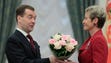 Russian President Dmitry Medvedev presents flowers