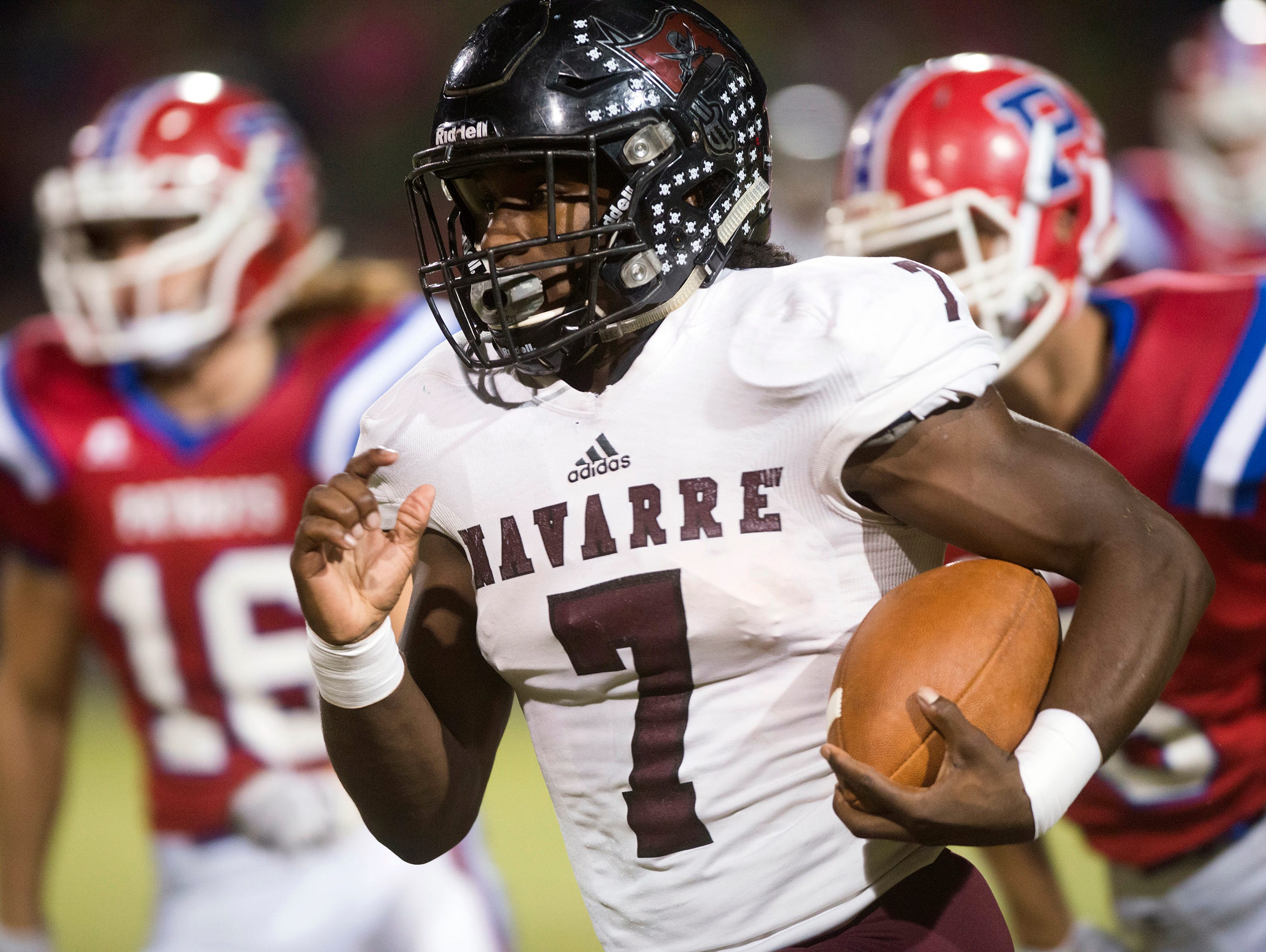 Navarre High School star running back Michael Carter (No. 7) runs for extra yards against the Pace High School defense during Friday night's District 2-6A matchup.