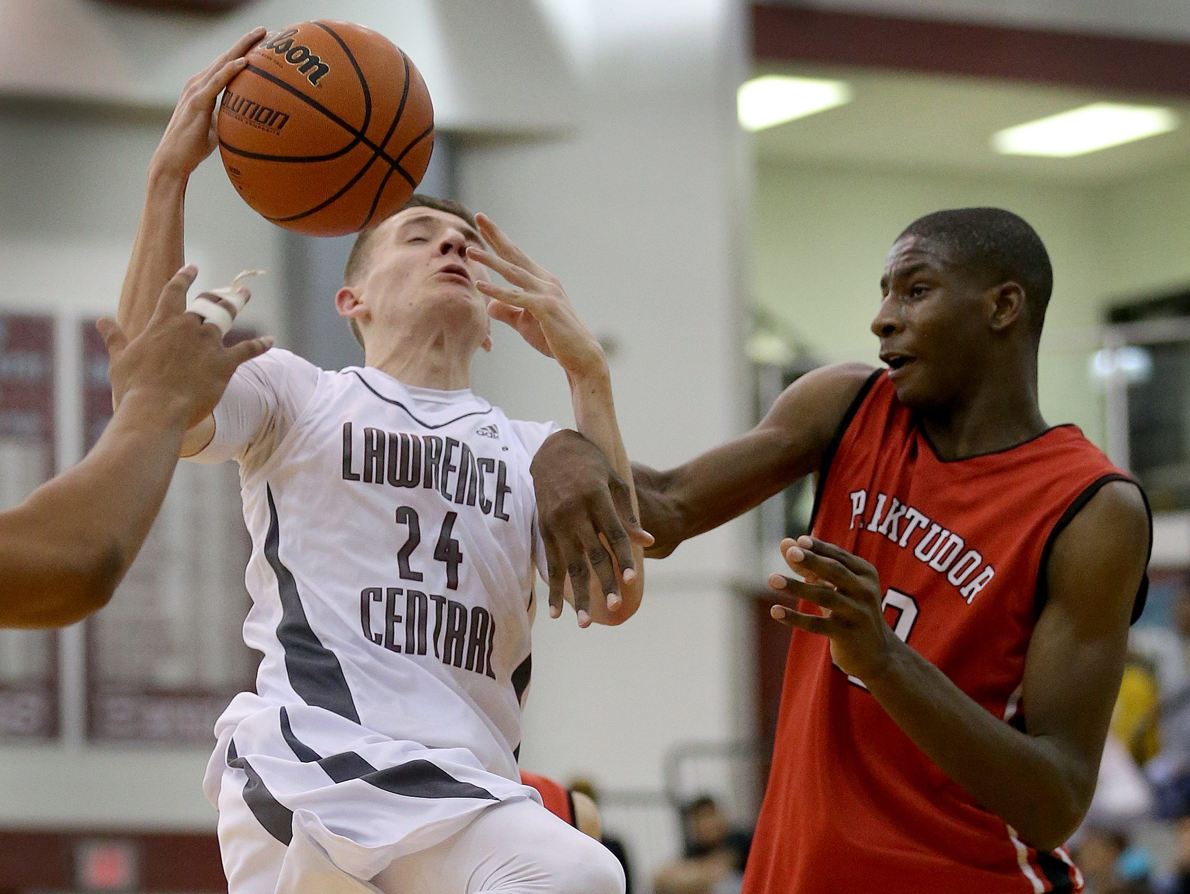 Lawrence CentralÕs Kyle Guy (24) is fouled by Park TudorÕs Jaren Jackson Jr. (32) in the second half of their game Wednesday, Jan 6, 2016, evening at Lawrence Central High School.
