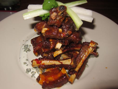 The crispy wild boar ribs are a signature appetizer and come in a huge tower of tiny riblets accompanied by crumbled bleu cheese.