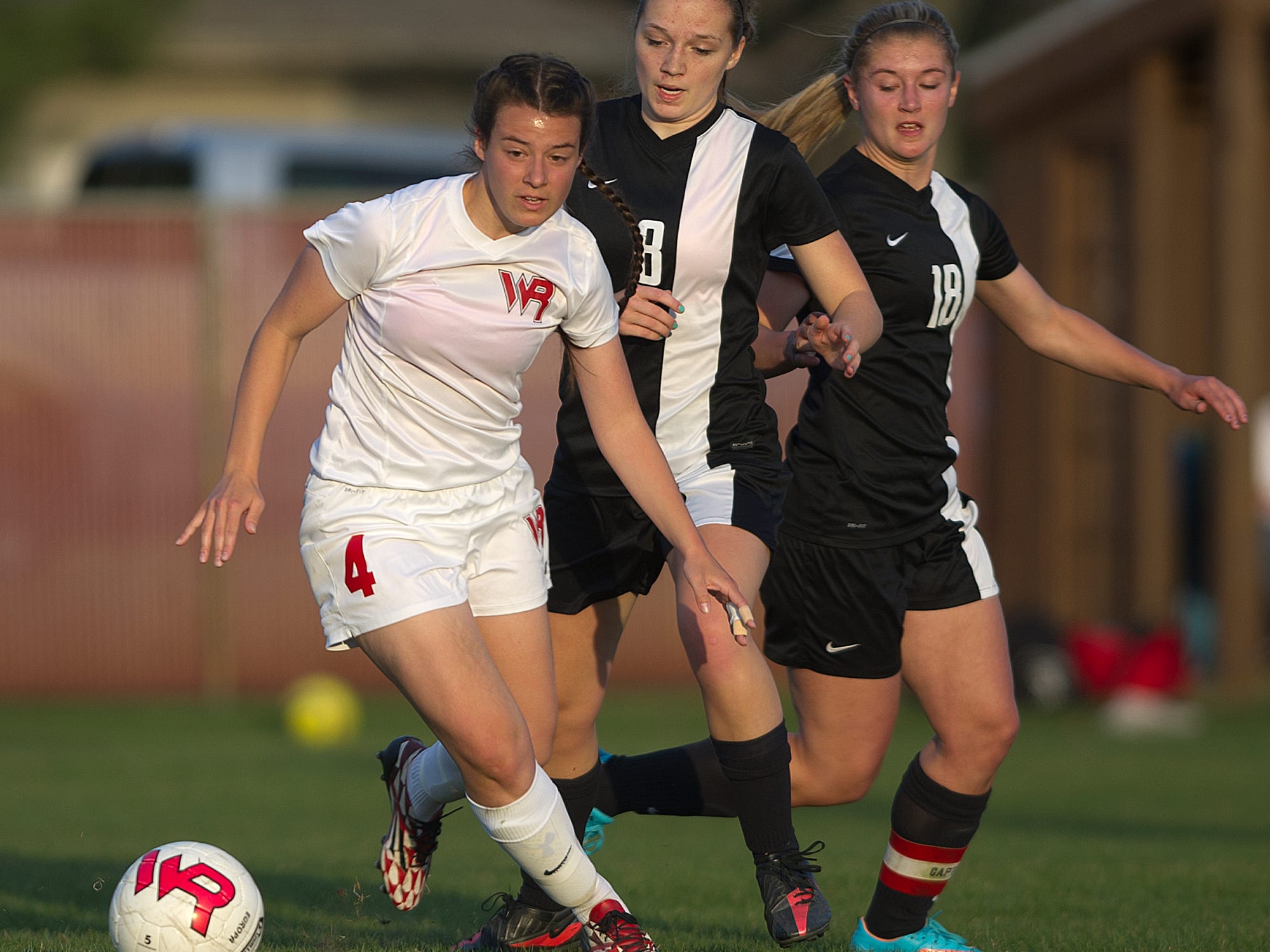 Wisconsin Rapids' Katie Kiiskila, left, moves past Stevens Point Area Senior High’s Sarah Rosenthal, center, and Abby Bohanski during a Wisconsin Valley Conference soccer game Tuesday at Washington Field in Wisconsin Rapids.