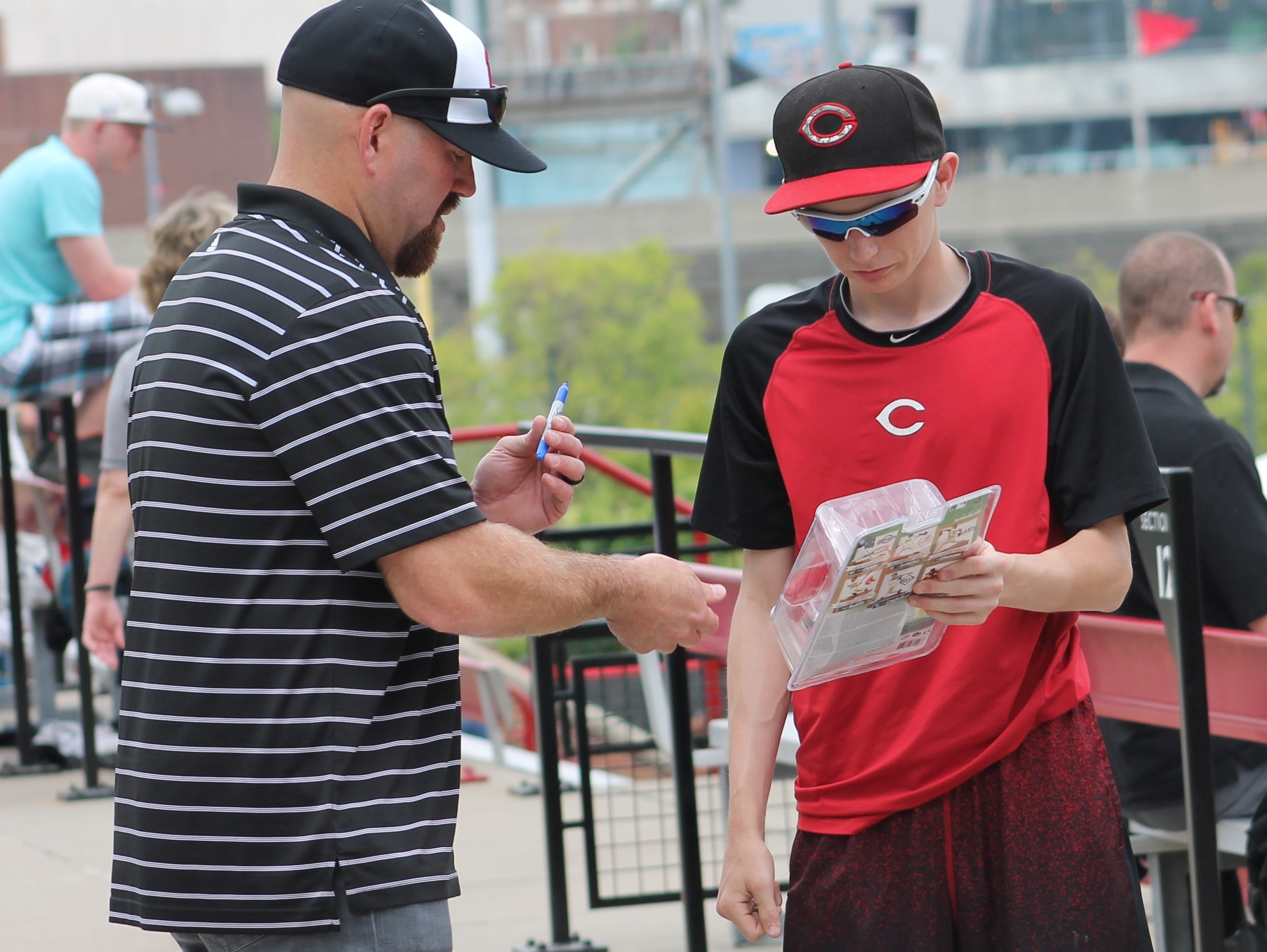 Former University of Cincinnati and Major League Baseball player Kevin Youkilis signs an autograph for a fan May 16 at Marge Schott Stadium. The Bearcats retired the No. 36 of Youkilis.
