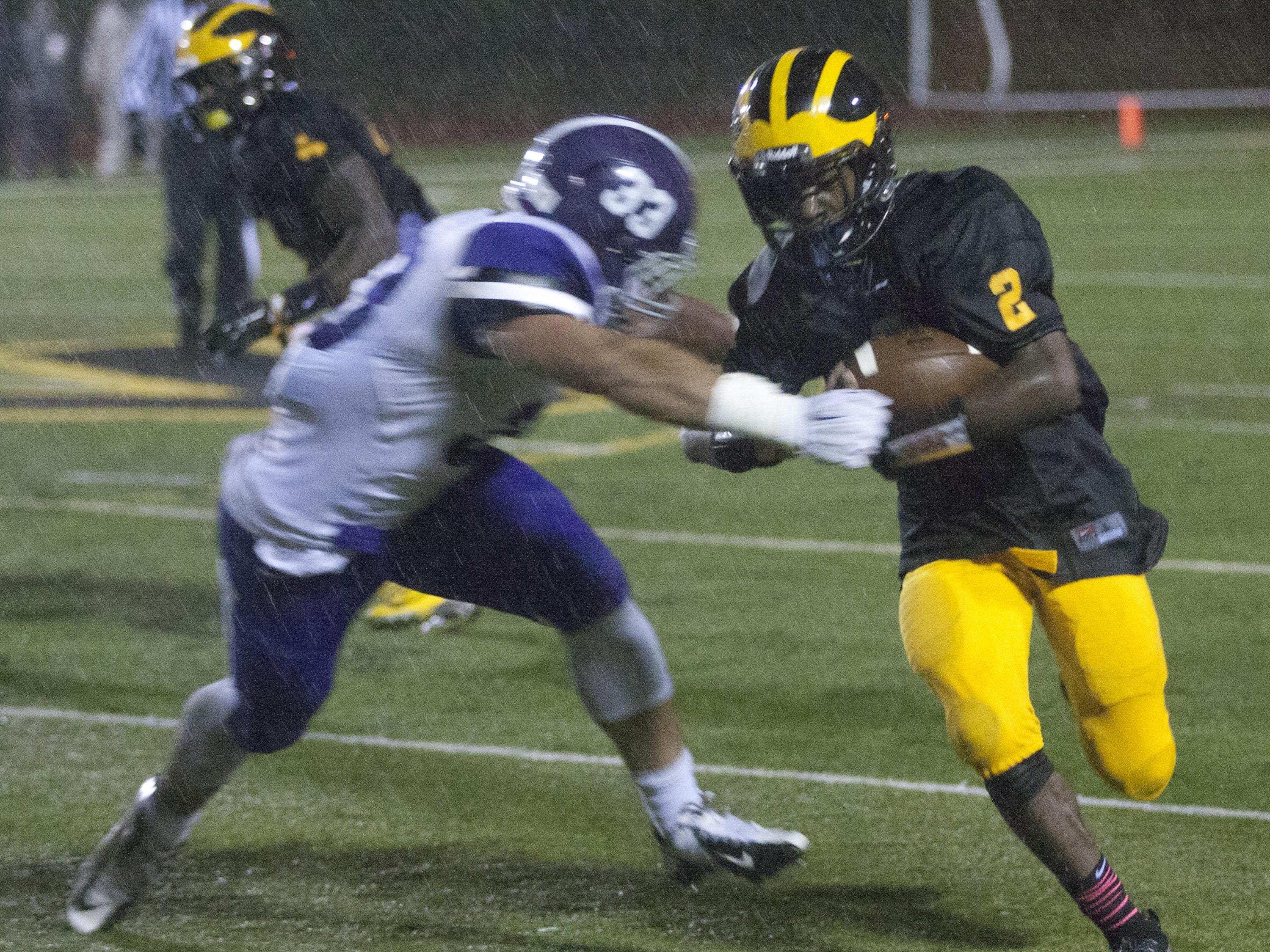 St. John Vianney's Khalil Haskins tries to outrun Rumson's Mike Ruane during first half action. Rumson-Fair Haven Football vs St John Vianney in Holmdel, NJ on October 2, 2015.