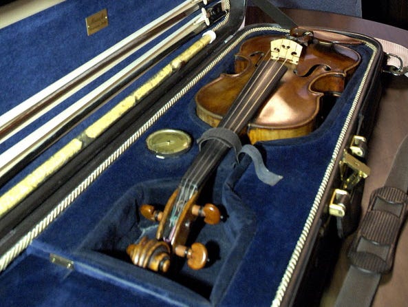 Billings, Mont., Police Chief Rich St. John holds a news conference Dec. 20, 2006, to announce the recovery of an 1879 Eugenia Praga violin valued at $50,000, which had been stolen from the Billings airport.