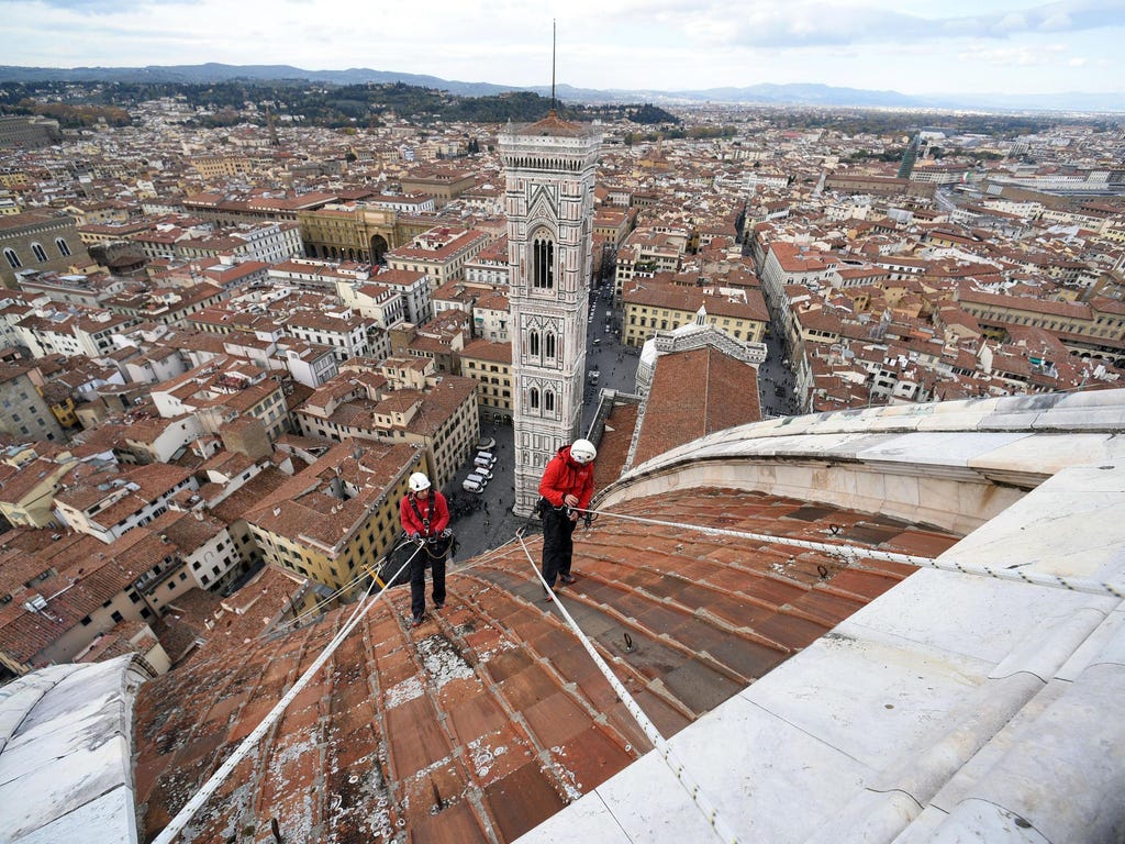 Experts working to control the marble surfaces of the Duomo and the bell tower of Giotto in Florence, Italy.