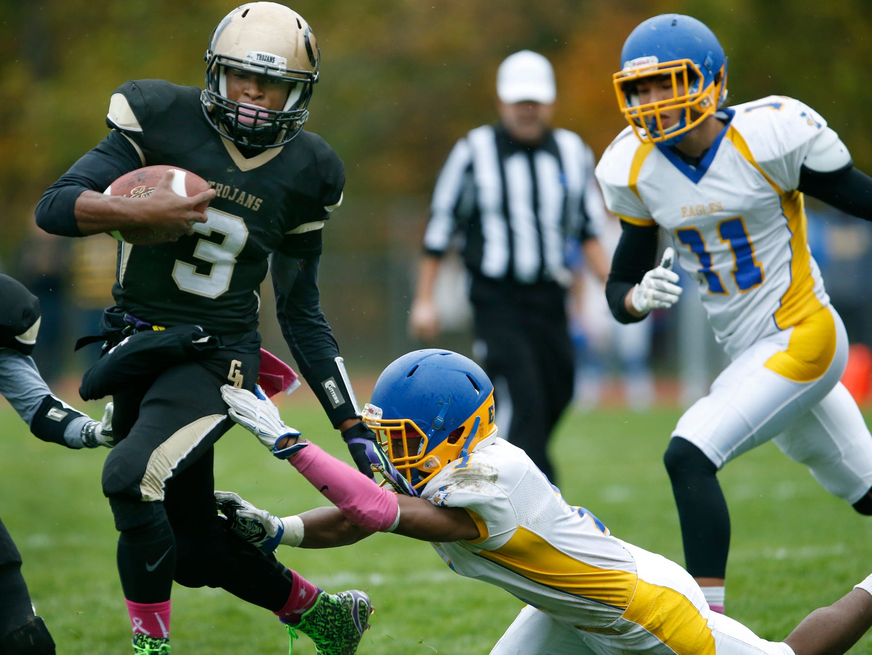 Greece Athena's Ta'Von Granison avoids a tackle by Irondequoit's Fooquan Peace to score in a play that would end up in a 14-6 lead for the Trojans in the first quarter at Greece Athena High School.