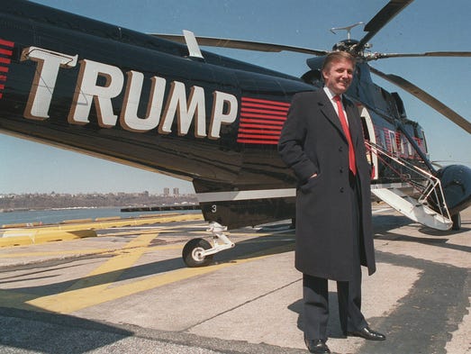 Donald Trump stands next to one of his three Sikorsky