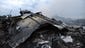 A person looks at debris from the Malaysia Airlines jet.