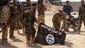 Iraqi security forces display a captured Islamic State flag.