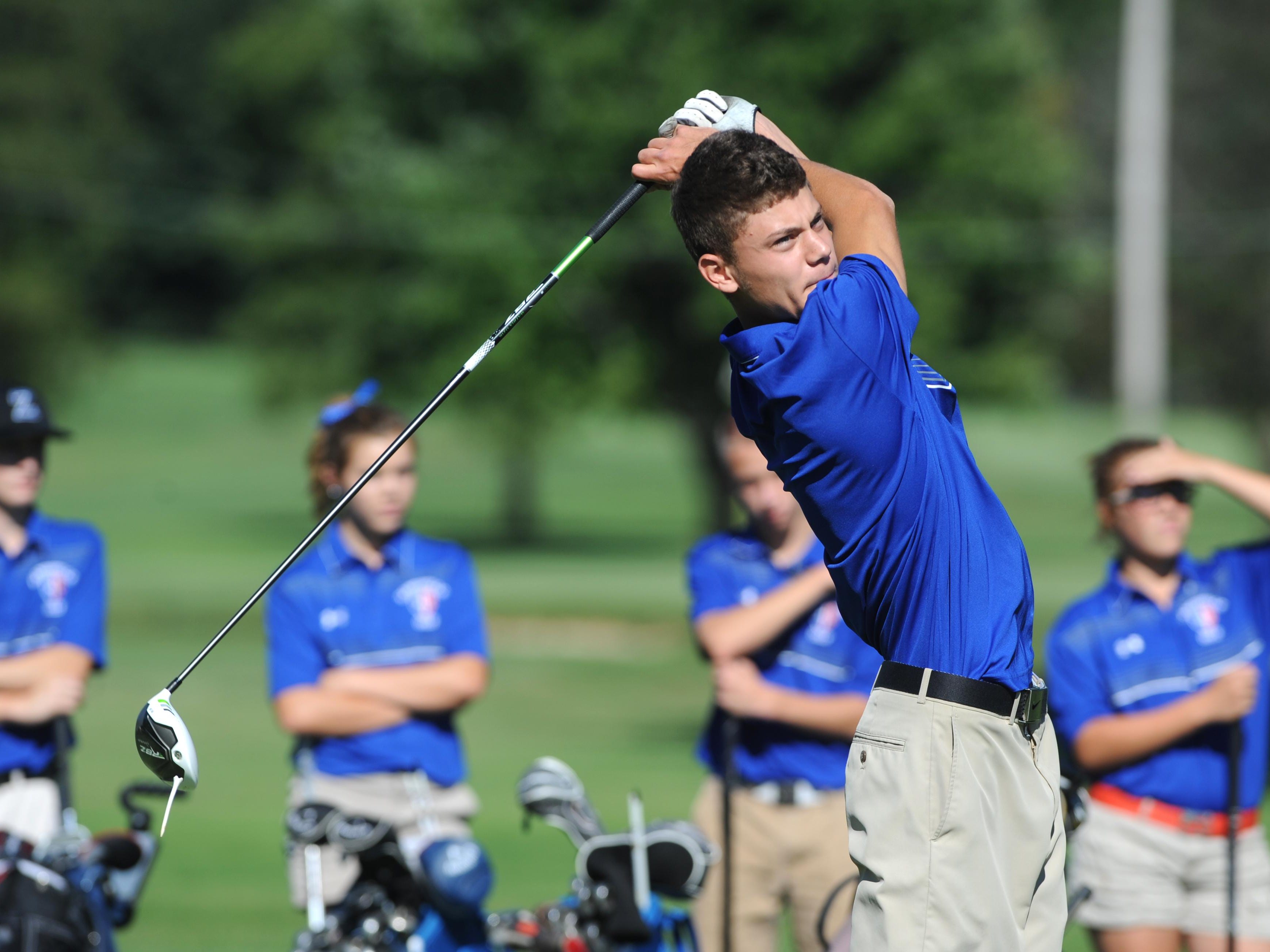 Zanesville's J.J. Burns tees off during the Michele Redman Cup at Zanesville Country Club on Monday.
