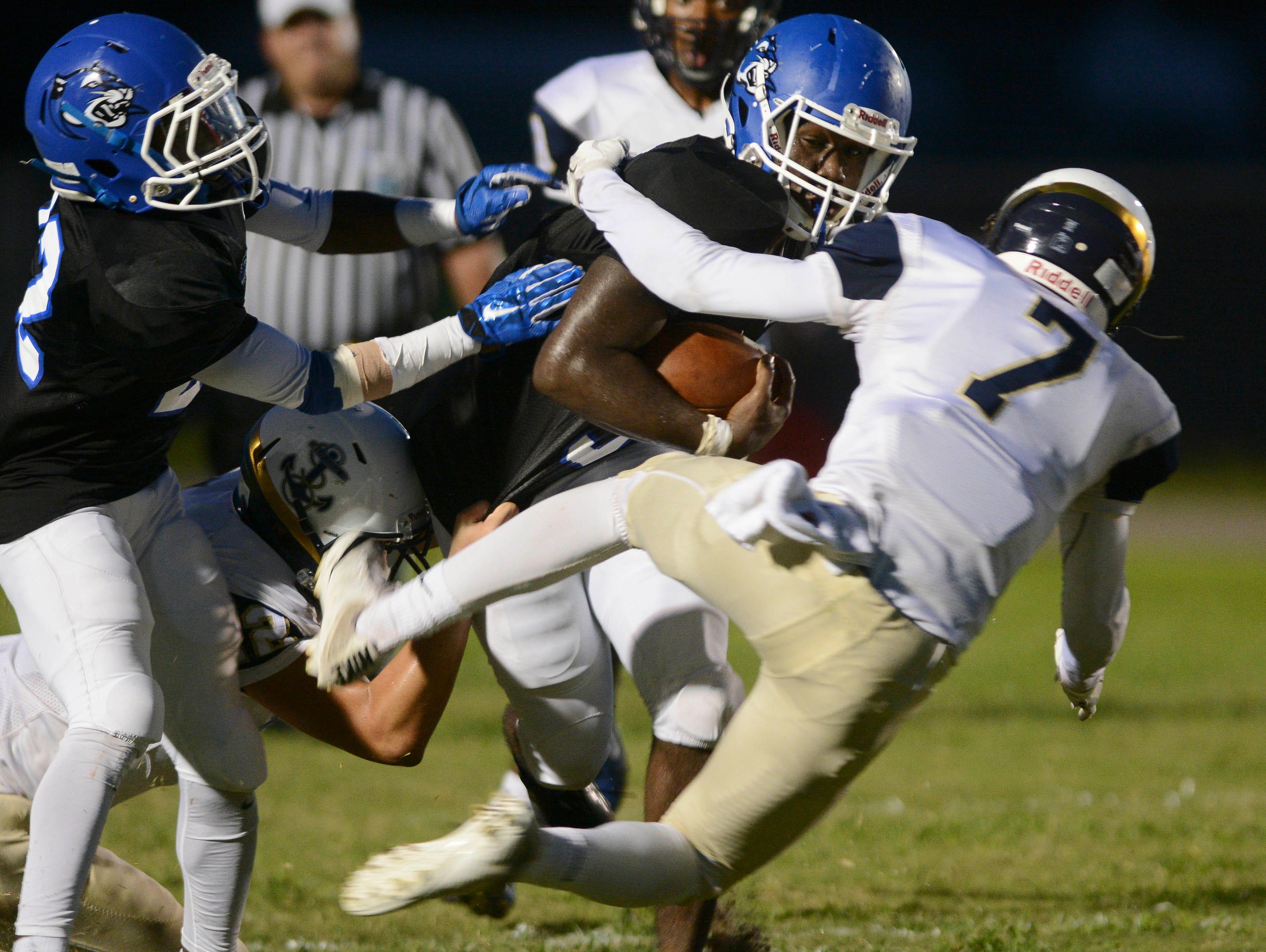 Negail Wright of Heritage is tackled by Josh Moo of Eau Gallie (7) during Friday's game in Palm Bay.