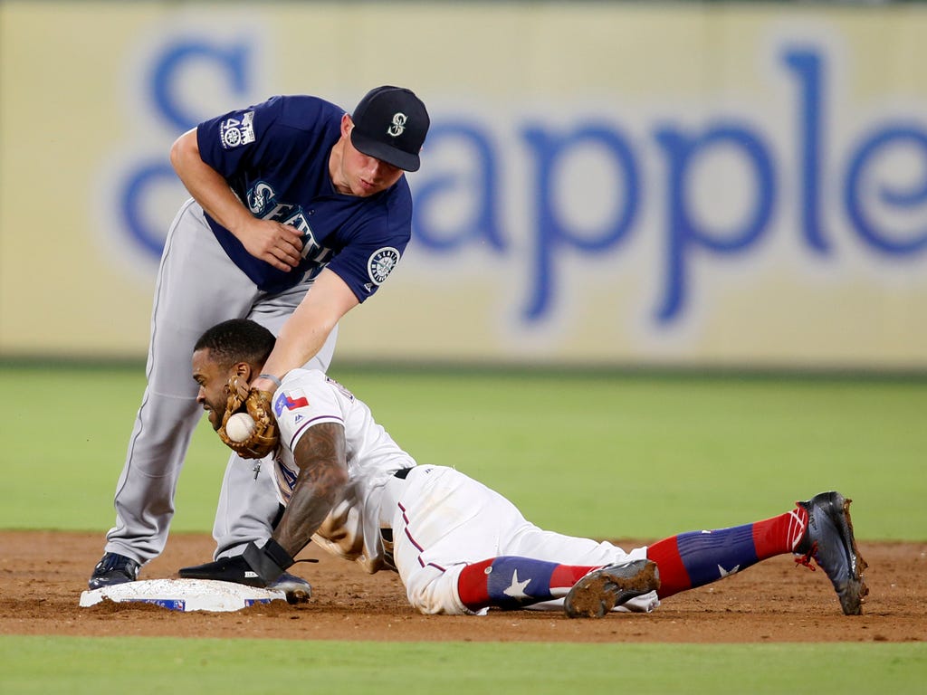 Seattle Mariners third baseman Kyle Seager tags out Texas Rangers center fielder Delino DeShields  as he attempts to steal second base in the third inning at Globe Life Park in Arlington, Texas.