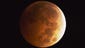The moon appears to be to have an orange-red hue as