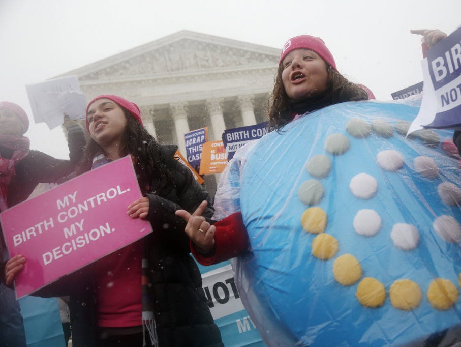 Margot Riphagen of New Orleans, La., wears a birth control pills costume as she protests in front of the Supreme Court in Washington, Tuesday, March 25, 2014, as the court heard oral arguments in the challenges of President Barack Obama's health care