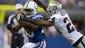 Oakland Raiders cornerback Charles Woodson (24) tackles Indianapolis Colts running back Vick Ballard (33) at Lucas Oil Stadium.