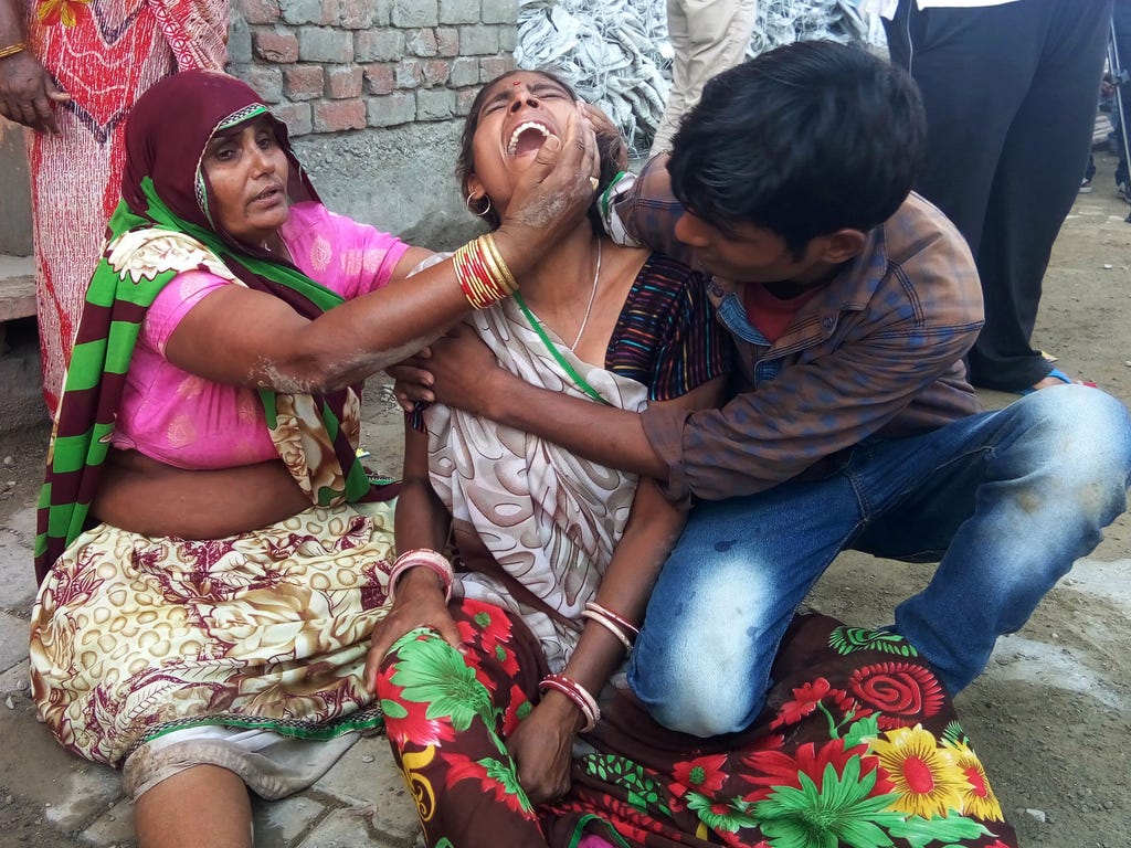 A woman cries after a wall collapsed during a wedding, killing at least 24 people, in Bharatpur in India's Rajasthan state.
