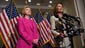 Clinton listens as House Minority Leader Nancy Pelosi,