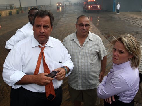 In this photo provided by the Office of the Governor of New Jersey, Deputy Chief of Staff Bridget Anne Kelly, right, stands with Gov. Chris Christie, left, during a tour of the Seaside Heights, N.J., boardwalk after it was hit by a massive fire Sept.