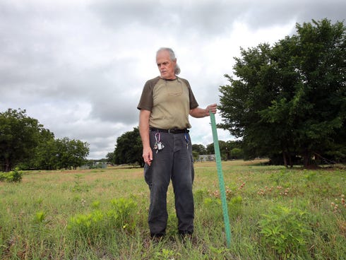 David Hull stands on the area of his property that is thought to be the epicenter of a recent earthquake in Reno, Texas.  The ground, once flat, has small rolls and changes in height.  Hull blames a nearby fracking well.