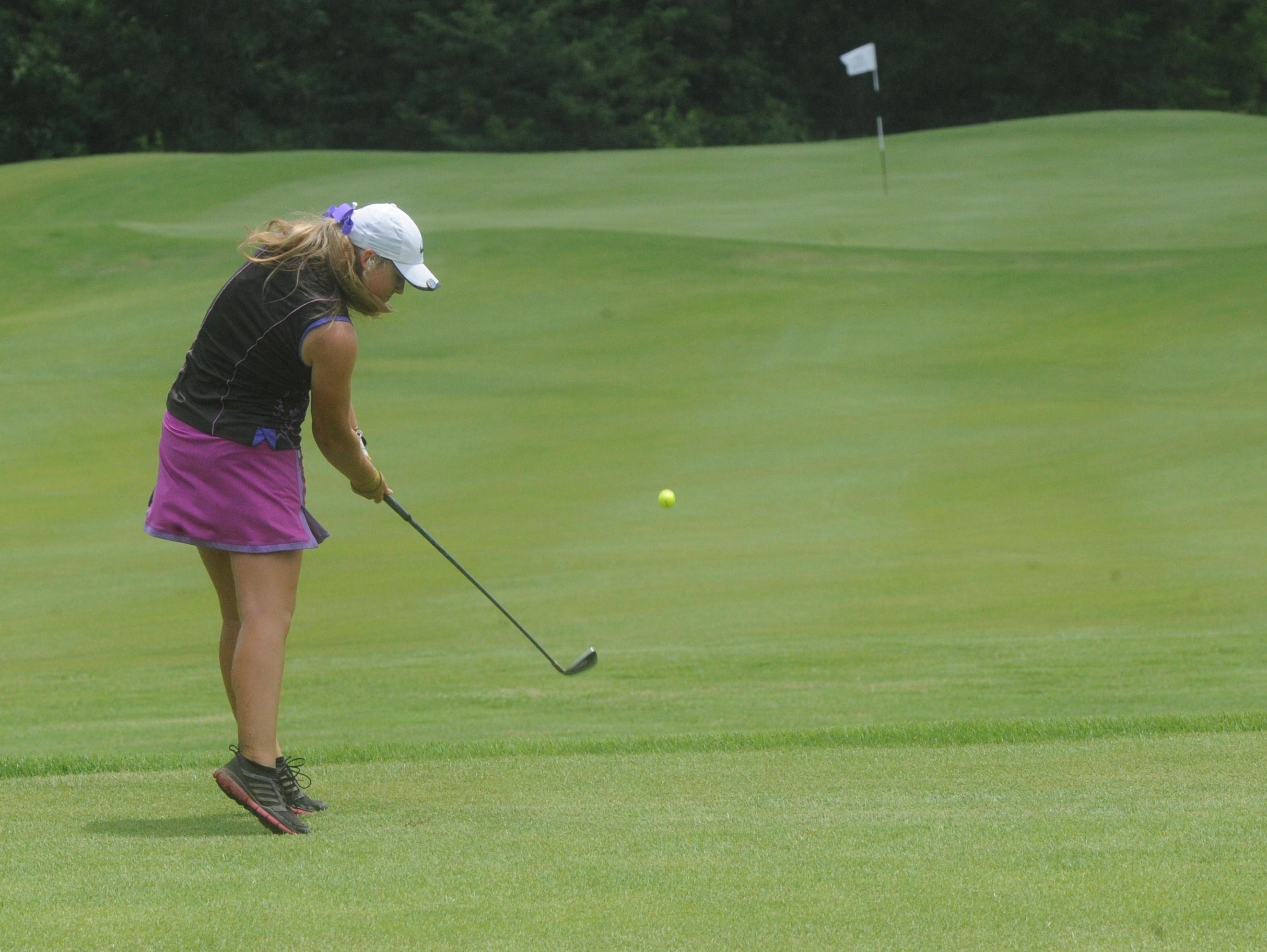 Josie Roberson of Maumelle tees off on the par-3 17th hole at Big Creek Golf & Country Club on Thursday during first-round play of the 14th annual Chuck Morton Memorial Junior Golf Tournament.