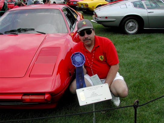 In 2004, John Ottino is photographed with a 1977 Ferrari
