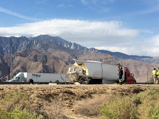 The rear of a big rig, after the tour bus that crashed