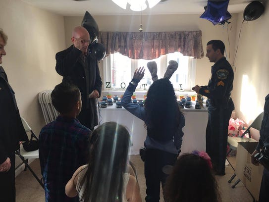 Malia Valdez, 7, is sworn in as a junior police officer