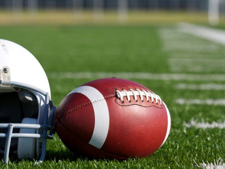 Football and Helmet on the Field