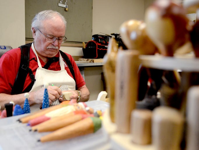Dave Disselbrett works in his woodcarving club at the