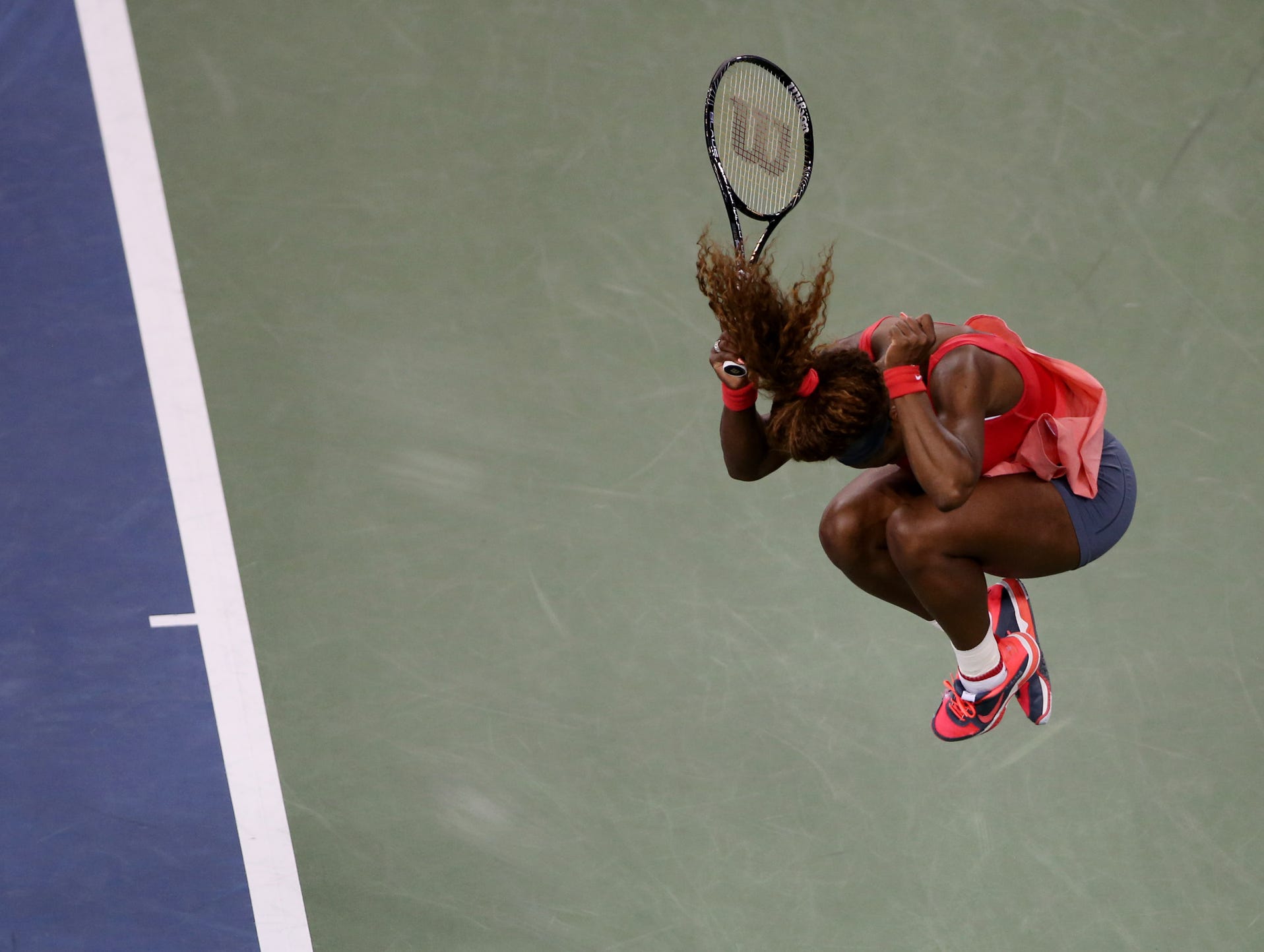 Serena Williams leaps after clinching the title.