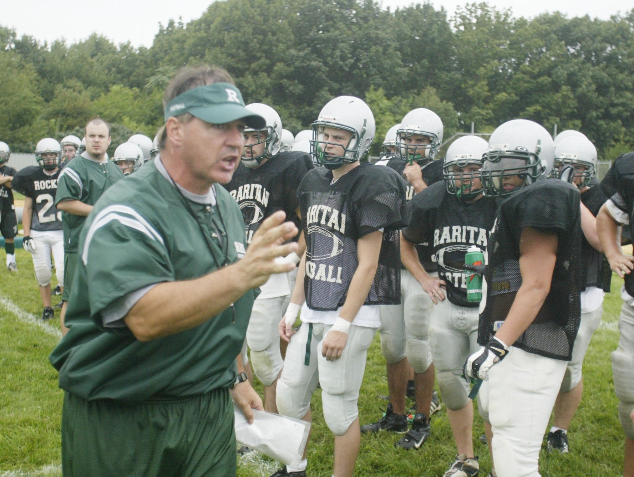 Bob Generelli talks to his Raritan players during a summer practice in 2004. The Rockets would go on to their only undefeated season in school history that year.