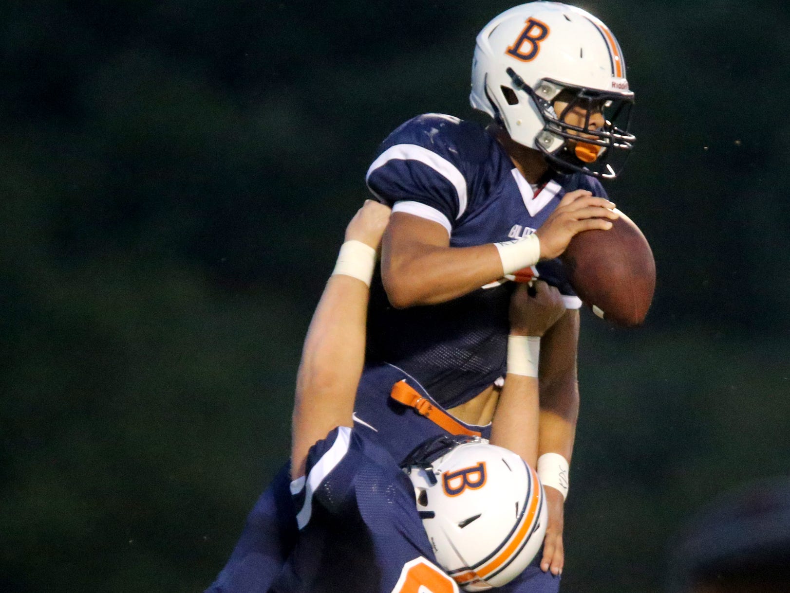 Blackman's Camron Curtis (65) hoists teammate Taeler Dowdy (3) in the air after Dowdy scored a touchdown Friday.