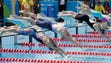 Competitors dive into the pool during the women's individual