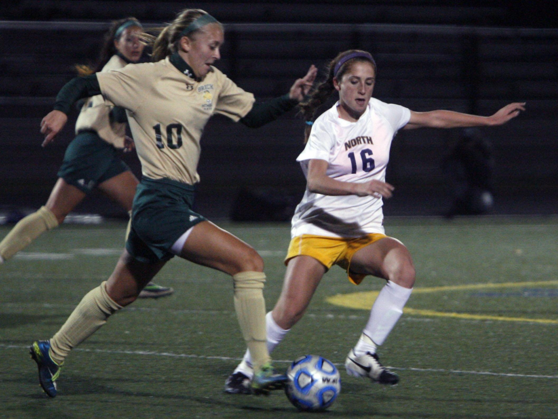 Emma Carney of Brick Memorial, left, fights for control with Toms River North's Melissa Wilhelm at Toms River North High School Nov. 2, 2015.