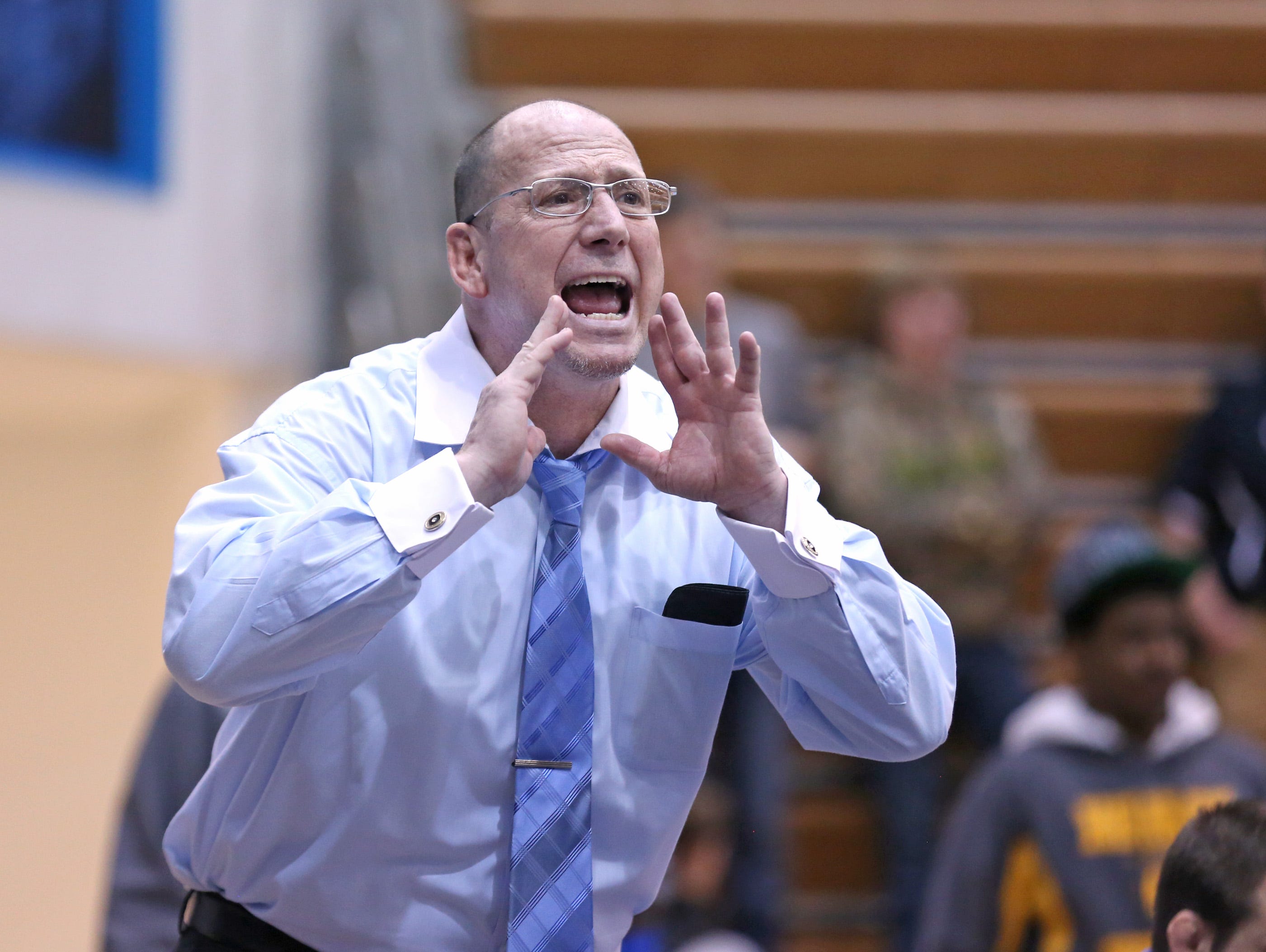 Perry Meridian head coach Jim Tonte calls out to a competitor during the wrestling regional finals at Perry Meridian High School Saturday February 8, 2014.