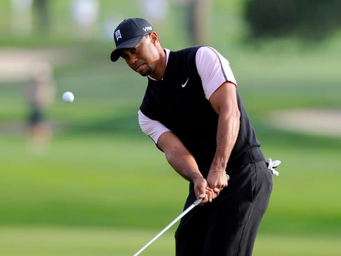 Jan 23, 2014; La Jolla, CA, USA; Tiger Woods hits a chip shot on the fifteenth hole during the first round of the Farmers Insurance Open golf tournament at Torrey Pines Municipal Golf Course.