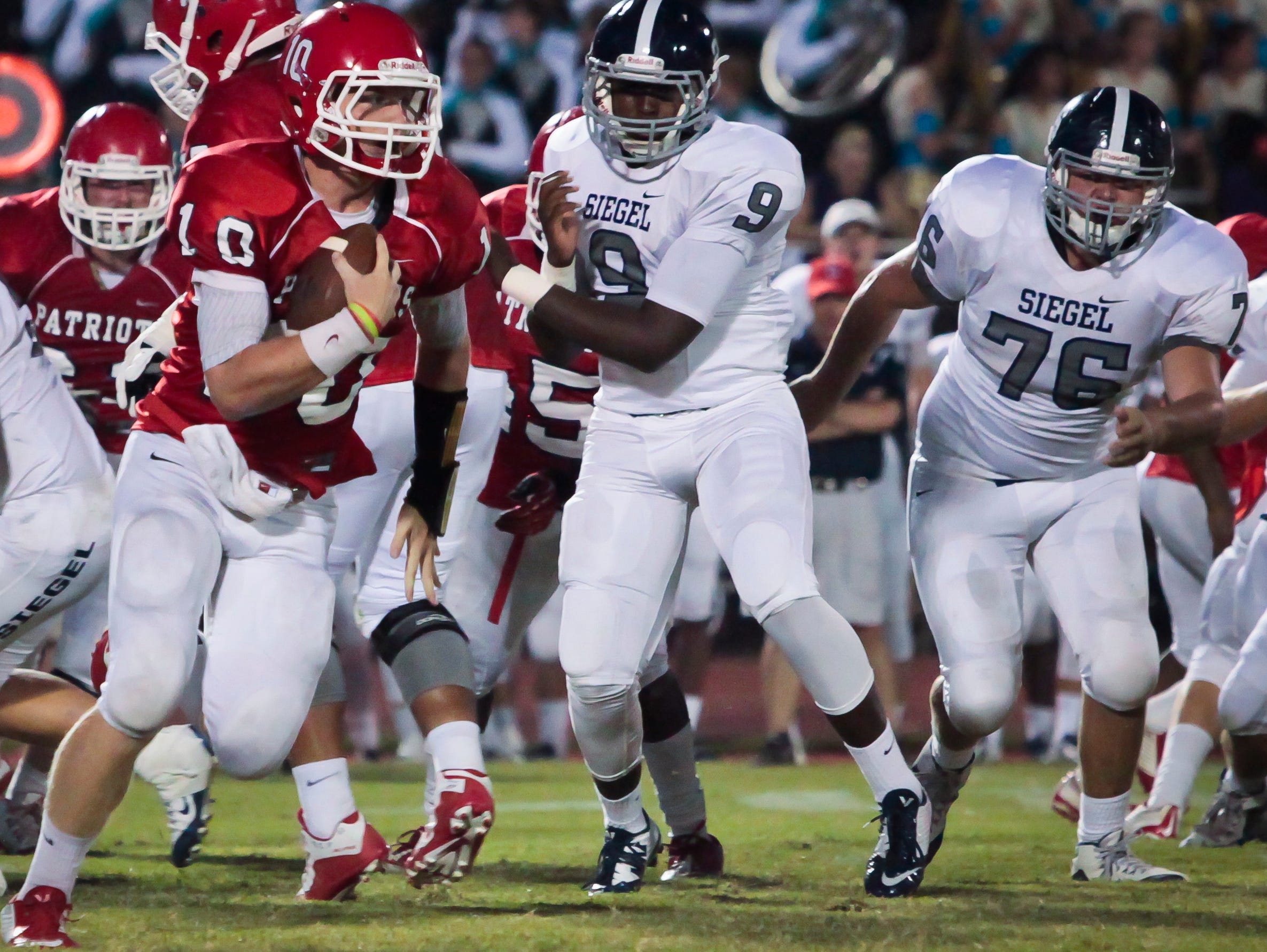 Oakland quarterback Brendan Matthews carries the ball during the Patriots' win over Siegel.