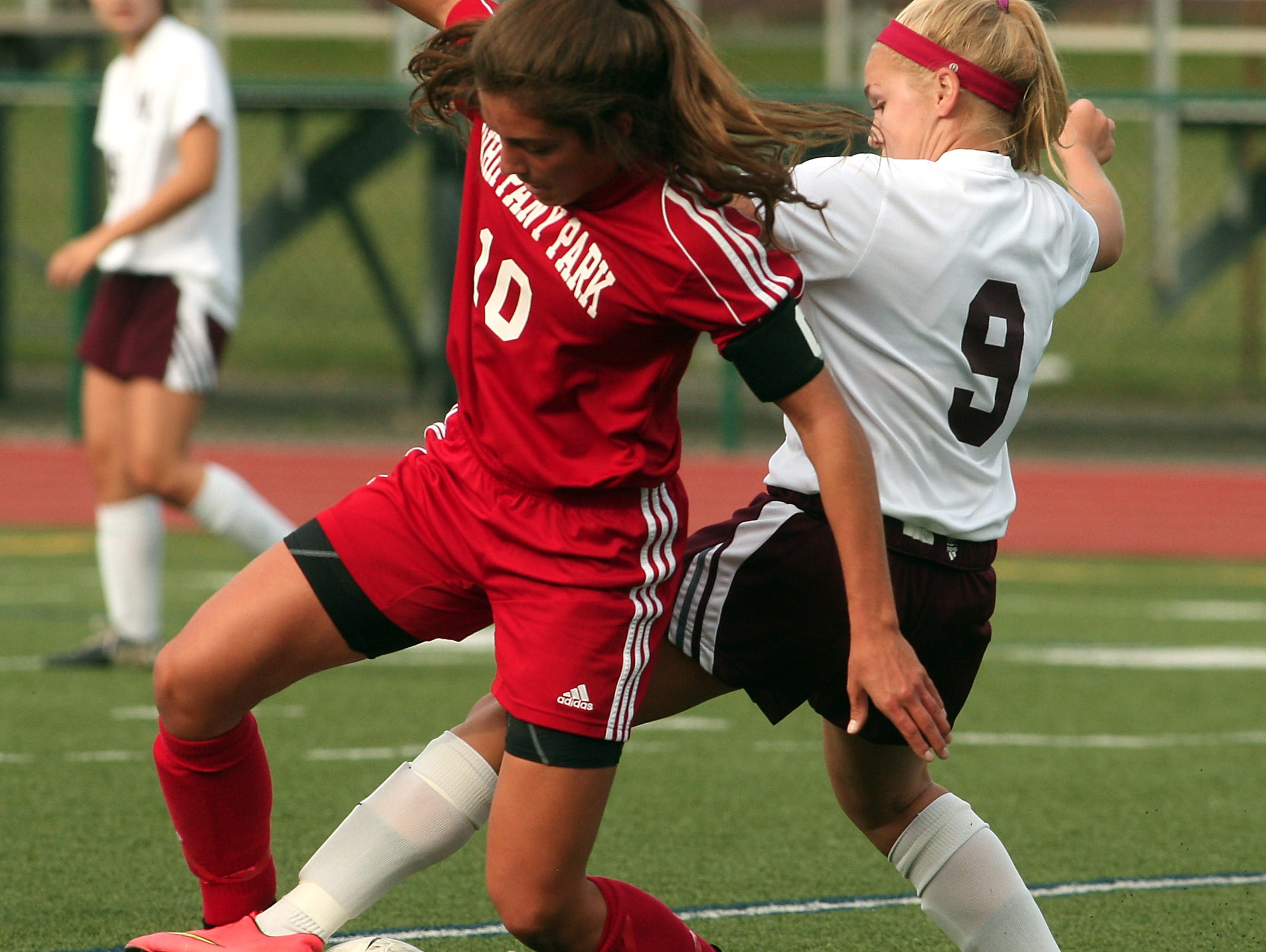 Whippany Park's Gina DelloRusso, l, and Madison's Emily Pruzik battle for the ball during their girls soccer matchup. September 22, 2015, Madison, NJ.