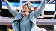 Summitt waves to the fans as her son Tyler holds the