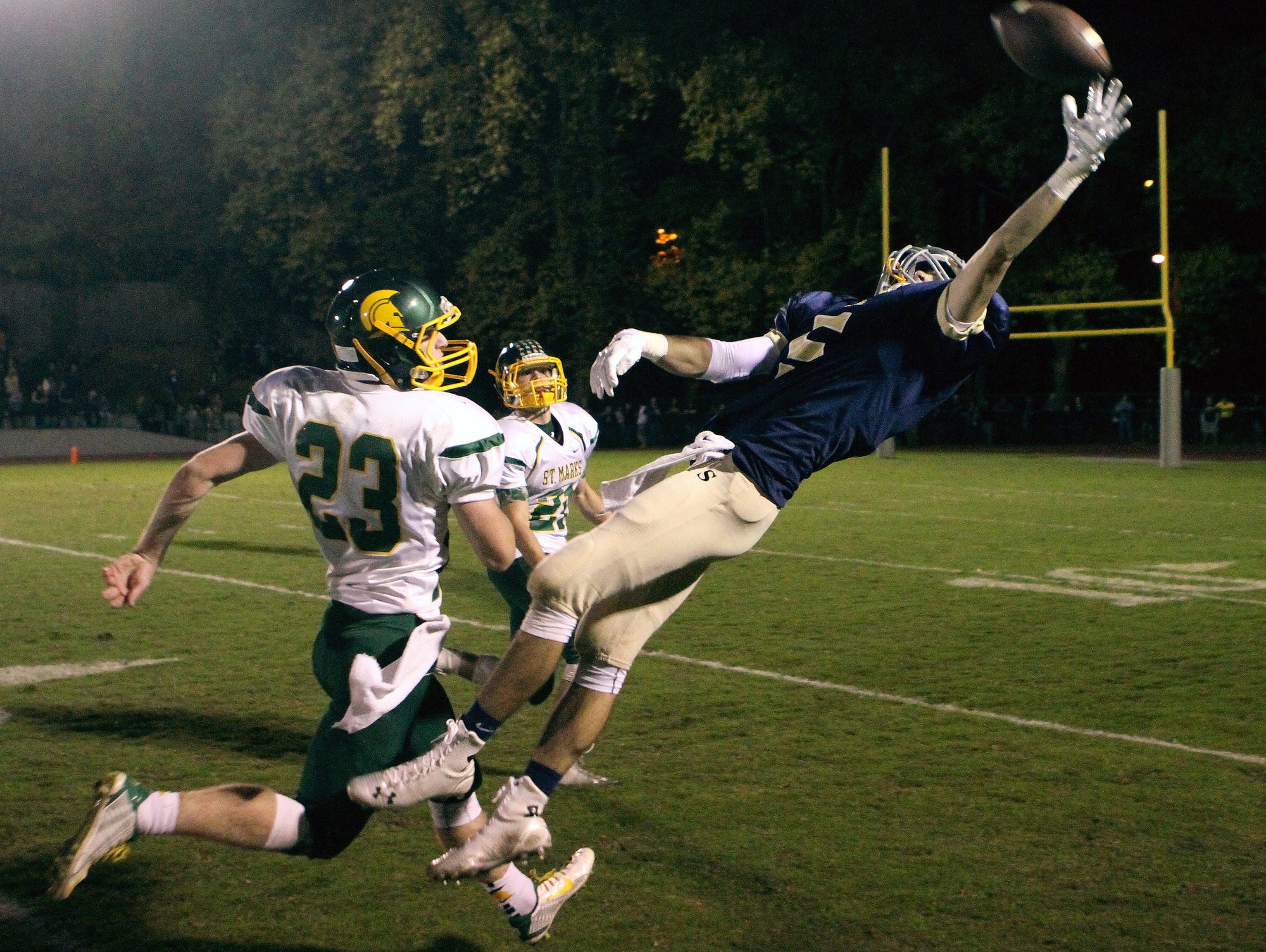 A pass goes off the fingertips of Salesianum's Jeremy Ryan as St. Mark's Greg Betts (left) and Rhett Schweizer defend during last year's 28-21 St. Mark's win at Baynard Stadium.