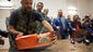 A pro-Russia militant carries an aircraft flight recorder retrieved from the Malaysia Airlines crash site as Donetsk People's Republic officials present the device to Malaysian representatives in Donetsk.