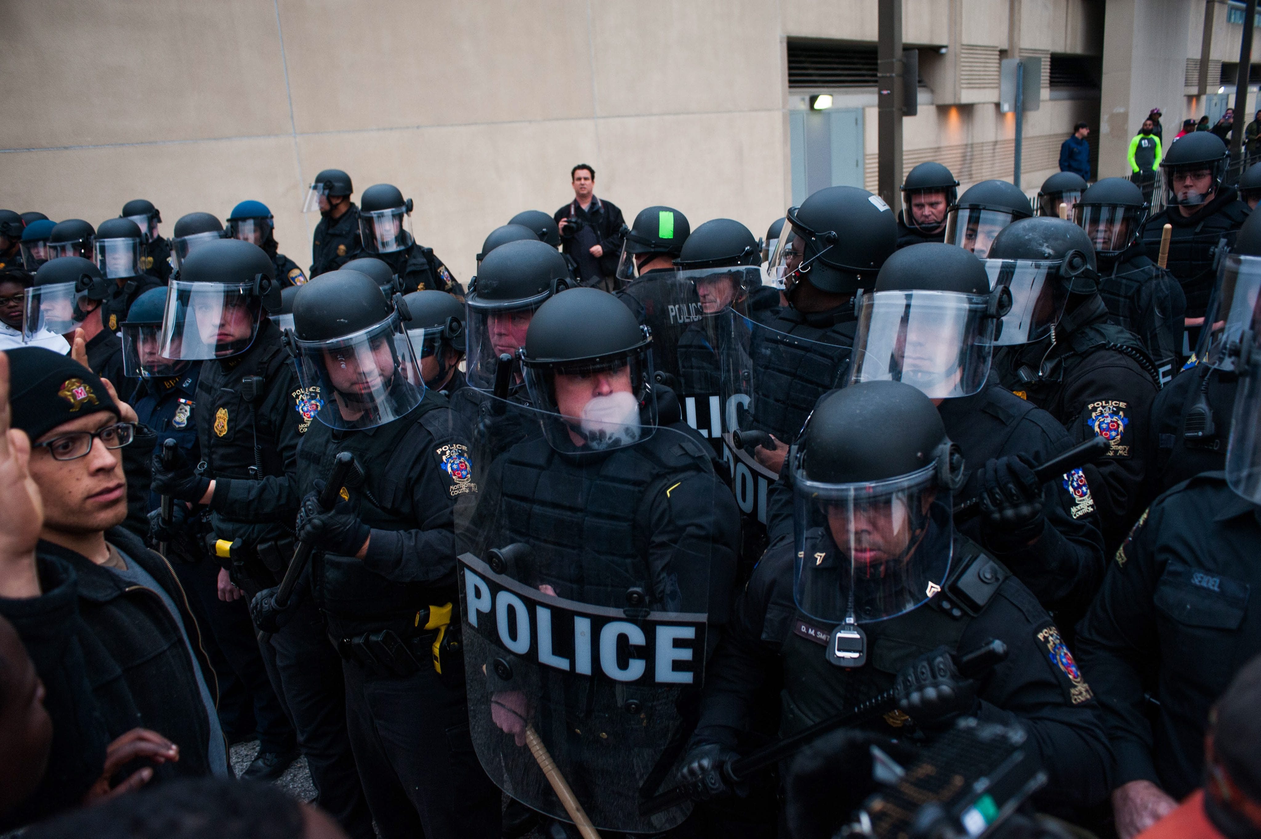 Baltimore police, protesters clash; college closed