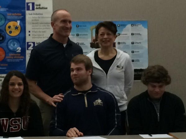 Keegan Bray (center) poses with family. He will play football at Montana State University.