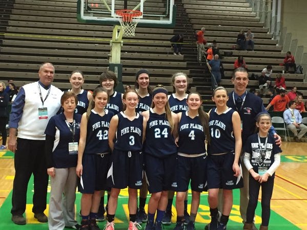 The Pine Plains girls basketball team poses for a photo after winning a state semifinal game on March 12.