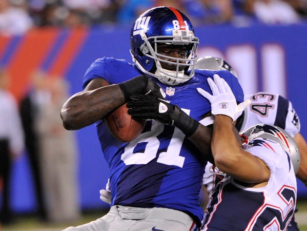 New York Giants tight end Adrien Robinson (81) is tackled by New England Patriots' Sterling Moore (29) during the second half of a preseason NFL football game Wednesday, Aug. 29, 2012, in East Rutherford, N.J. (AP Photo/Bill Kostroun)