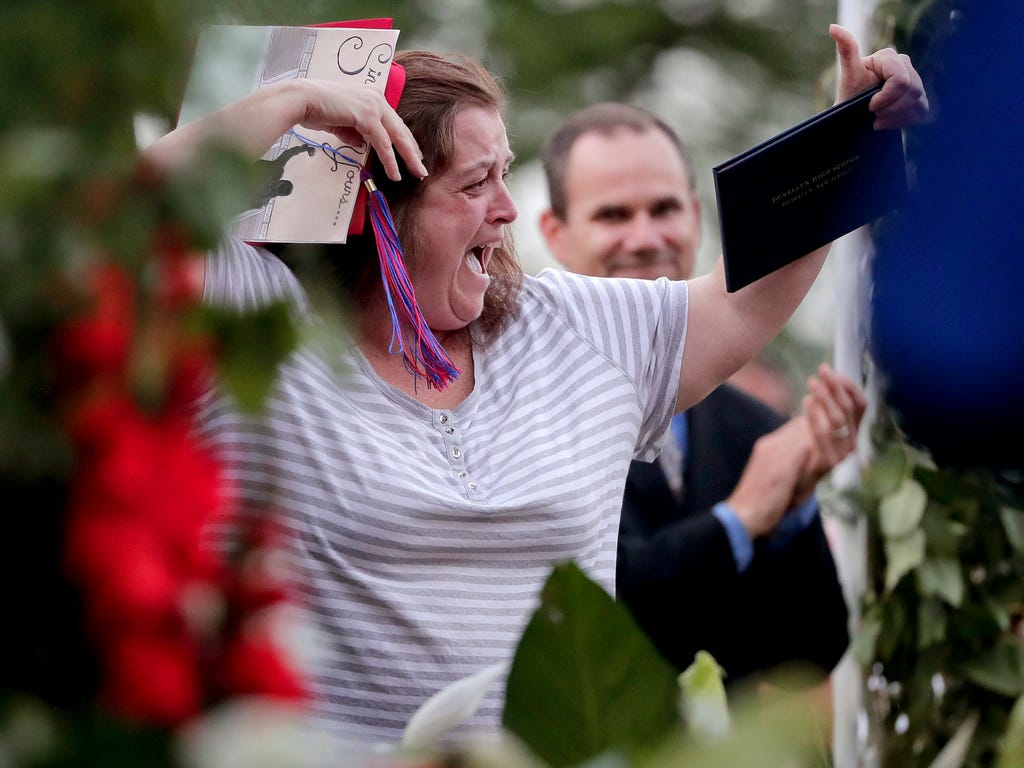 Elaine Williams, mother of Times Square crash victim Jessica Williams, cheers and waves a diploma after receiving the diploma for her daughter during Dunellen High School graduation ceremonies in Dunellen, N.J. Jessica, 19, was seriously injured when