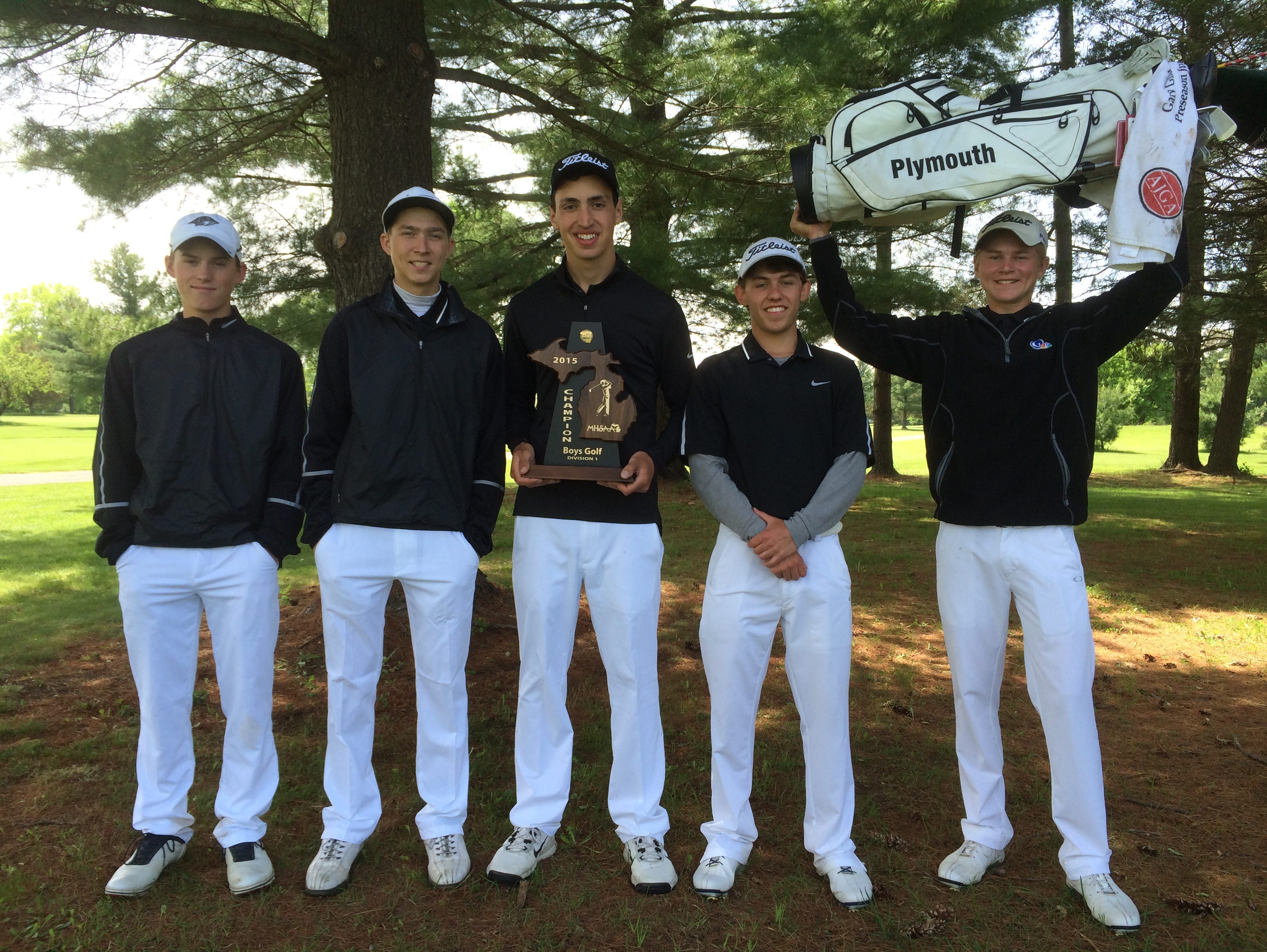 Plymouth’s varsity boys golf team celebrates after winning Wednesday’s Division 1 district at Pine View Golf Course in Ypsilanti.