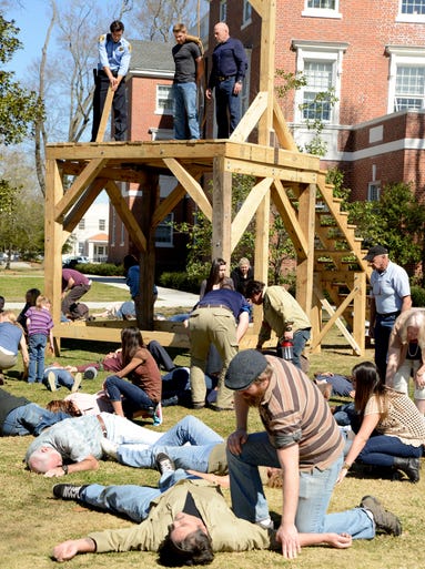 Changes in the Dome cause Chester's Mill residents to collapse just as Big Jim Rennie (Dean Norris), to the right on the scaffolding, plans to hang Dale "Barbie" Barbara (Mike Vogel). "Along with the bright light, there's something transformative happening where the Dome is maybe not so happy with what's going on," executive producer Baer says.