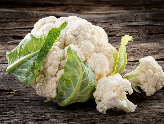 Organic cauliflower on wooden background